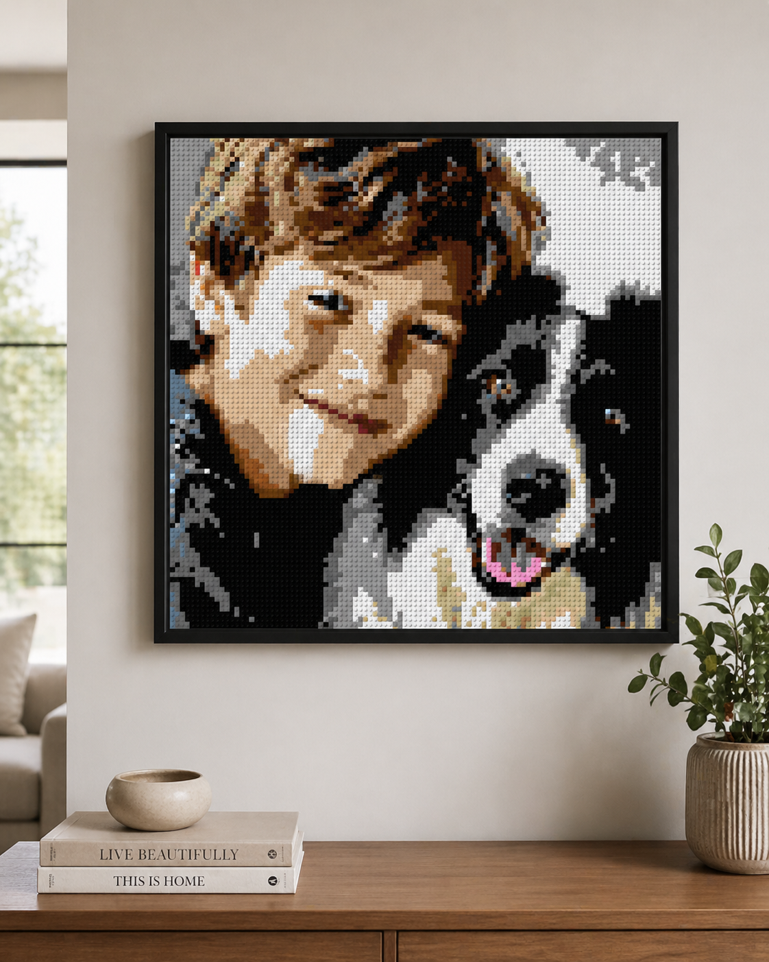 Framed custom LEGO-style brick mosaic portrait of a boy and his dog hanging on a wall